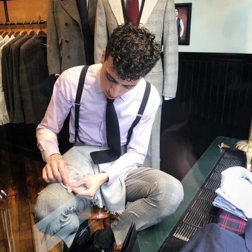 Tailor hand feathering a scarf