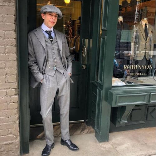 Model showing off a gray three piece suit