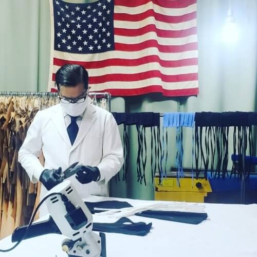 A man with white coat making face masks