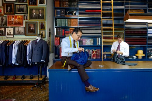 Tailors stitching suits