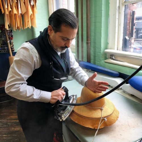 Robinson ironing out a new hat