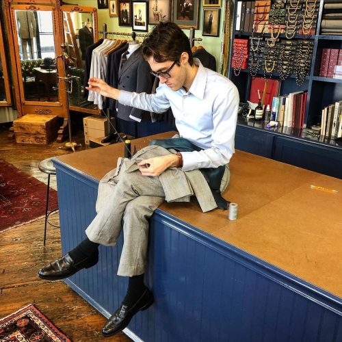 Tailor stitching a suit jacket