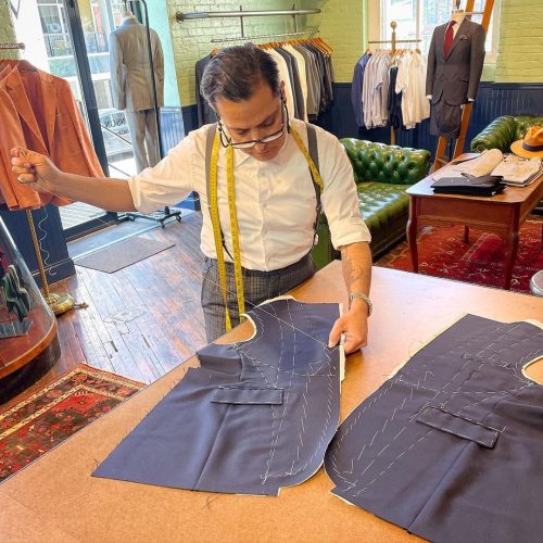 Robinson sewing the first stitches of a new suit