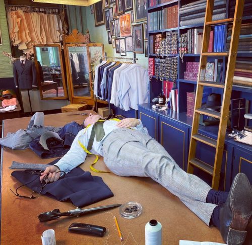 Tailor laying on the table, tired after working so hard