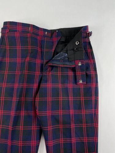 View of pant hooks, zipper and button on navy and red plaid dress pants