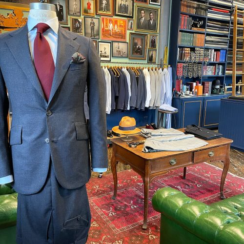 A charcoal suit on display in front of the store area