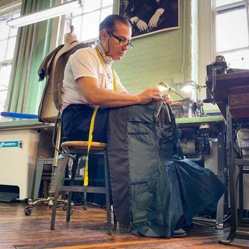 A tailor working on a new suit jacket