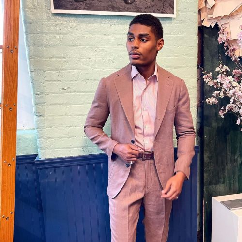 Model showing off beige suit