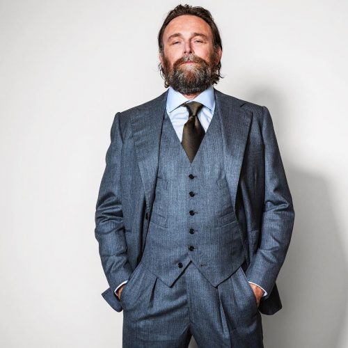 Model showing off a gray three piece suit