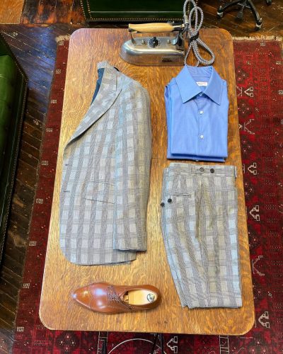 In store display of full suit set, pants, jacket, collared shirt and shoes